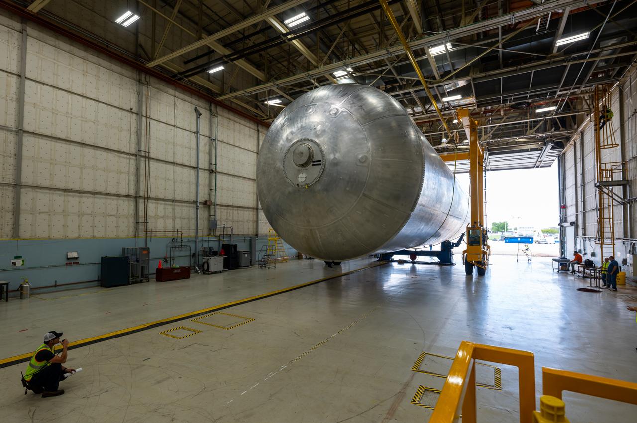 The core stage liquid hydrogen tank for the Artemis III mission completed proof testing, and technicians returned it to the main factory building at NASA’s Michoud Assembly Facility in New Orleans where it will undergo more outfitting. As part of proof testing, technicians apply a simple soap solution and check for leaks by observing any bubble formation on the welds. The technician removed the bubble solution with distilled water and then dried the area of application to prevent corrosion. To build the Space Launch System (SLS) rocket’s 130-foot core stage liquid hydrogen tank, engineers use robotic tools to weld five-barrel segments. This process results in a tank with around 1,900 feet, or more than six football fields, of welds that must be tested by hand. After the leak tests, the core stage lead, Boeing, pressurized the SLS tank to further ensure there were no leaks. After it passed proof testing, technicians moved the Artemis III liquid hydrogen tank to Michoud’s main factory. Soon, the technicians will prime and apply a foam-based thermal protection system that protects the tank during launch. Later, the tank will be joined with other parts of the core stage to form the entire 212-foot rocket stage with its four RS-25 engines that produce 2 million pounds of thrust to help launch the rocket. Artemis III will land the first astronauts on the lunar surface.